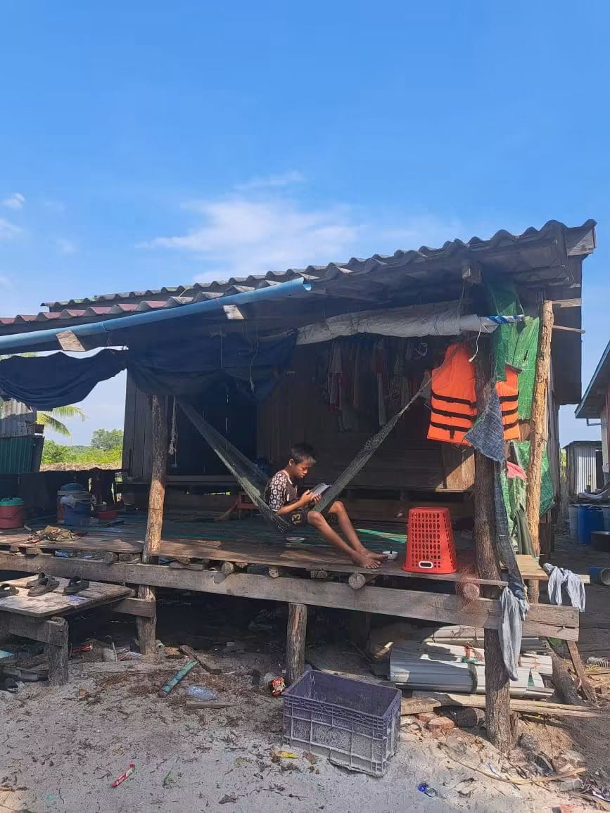 A child reading at home in a coastal village